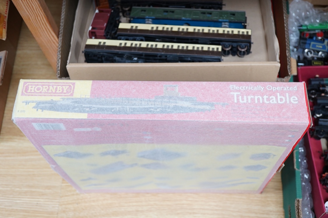 A quantity of 00 gauge model railway by Hornby, Tri-ang, etc. including nineteen locomotives in BR, GWR, LMS, etc. liveries, together with a boxed electrically operated turntable (R070), a terraced house (R8621) and a ga